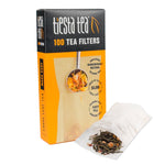Tiesta Tea box of 100 unbleached tea filters displayed next to an open filter pouch with loose leaf tea