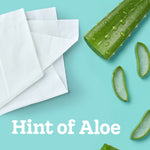 Flat-lay of folded white tissues beside sliced aloe pieces on a teal background with 'Hint of Aloe' text