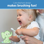 Happy toddler holding a mint elephant training toothbrush with a cartoon elephant illustration
