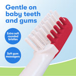 Close-up of a toddler toothbrush head with extra-soft rounded bristles and red soft gum massagers on the side