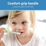 Toddler holding a mint elephant training toothbrush, close-up showing comfort-grip handle