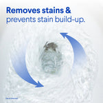 Close-up swirling toilet bowl water with arrows and text stating removes stains and prevents stain build-up