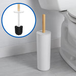 Toilet brush in a white cylindrical holder with a bamboo handle placed beside a toilet, inset shows brush head detail.