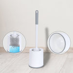 White toilet brush standing in matching white holder with insets showing brush soaking and holder detail