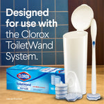 ToiletWand system caddy and handle displayed with a box of Clorox refills and several scrubbing pads on a tiled bathroom surface.
