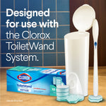 Lifestyle-style image of ToiletWand kit with caddy, wand and refills next to a box on tiled surface