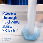 Action shot of a ToiletWand scrubbing pad cleaning the inside of a toilet bowl with text claiming it powers through hard water stains.