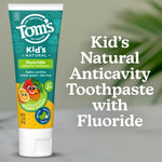 Tom’s of Maine Kid’s Natural fluoride toothpaste tube next to text reading Kid’s Natural Anticavity Toothpaste with Fluoride.