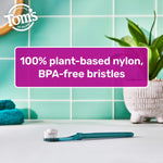 Tom’s toothbrush lying on a bathroom counter with text highlighting 100% plant-based nylon, BPA-free bristles