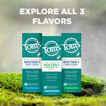 Three Tom’s toothpaste boxes standing on moss with headline text inviting shoppers to explore all three flavors