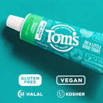 Angled close-up of a Tom's of Maine toothpaste tube on a teal surface with certification icons for gluten free, vegan, halal, and kosher.