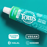 Angled Tom's toothpaste tube on teal background with icons for gluten free, vegan, halal and kosher visible beneath it