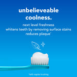 Close-up of a toothbrush head with toothpaste on it and text promoting coolness and freshness on a blue background