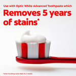 Red toothbrush head topped with a dollop of white toothpaste and bold text reading "Removes 5 years of stains".