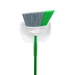 Top-down view of Libman angle broom with green and gray bristles nested in a white dustpan