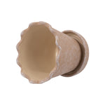 Top-down view of a brown ceramic planter showing scalloped wavy rim and unglazed interior.