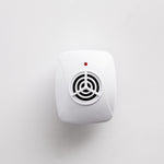 Top-down studio image of a white ultrasonic pest repeller centered on a light background with visible grille and red LED