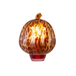 Glowing tortoiseshell pumpkin plug-in fragrance warmer shown head-on against white background