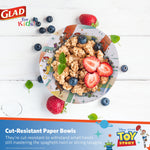 Top-down styled bowl of cereal and fruit served in a Glad Toy Story paper bowl on white wood surface