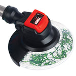 Angled close-up of toy trimmer gearbox with red POWER label and clear guard containing green decorative material