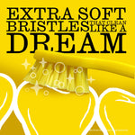 Macro view of yellow toothbrush bristles with text proclaiming “EXTRA SOFT BRISTLES” and illustrated sparkle effects.