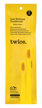 Yellow product pouch labeled “twice.” with text about extra-soft bristles and printed images of two yellow toothbrushes.