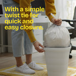Person lifting a tied white trash bag from a small bin with headline text about a simple twist tie for quick closure