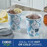 Two Dixie To Go patterned paper cups on a kitchen counter, one with ice and lemon slices and one steaming hot