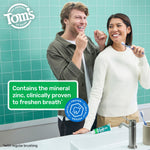 Two people smiling in a bathroom setting with Tom's of Maine Wicked Fresh toothpaste tube on the counter and a text panel about zinc freshening breath.
