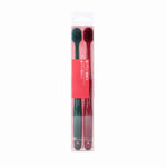 Two slim manual toothbrushes in a clear retail blister pack with a red label, one green and one red handle.
