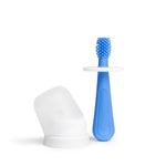 Blue silicone baby training toothbrush with round white safety guard next to a translucent protective cap on a white background.