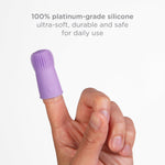 Adult finger wearing a purple silicone finger toothbrush against a white background with text about 100% platinum-grade silicone.