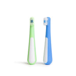 Two toddler toothbrush heads and ergonomic handles in green and blue on a white background.