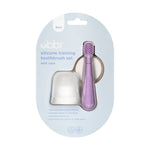 Ubbi silicone training toothbrush and translucent case presented in a retail blister pack on a pale blue backing card.