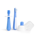 Three blue toddler toothbrush training pieces including silicone finger brush, soft-bristled brush and white cover/base on white