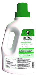 Rear view of Udder Magic bottle showing instructions text, handle and green cap on a white plastic jug.