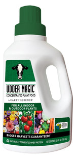 White jug of Udder Magic concentrated plant food with green cap and label showing cow logo and produce photos.