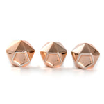 Underside view of three copper geometric succulent pots showing flat bases and small drainage holes