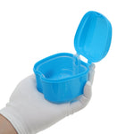 Open blue Unique Bargains retainer case held in a gloved hand showing interior tray and hinge on white background