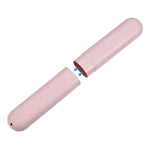 Pink toothbrush travel case partially separated to show how the two halves connect, blue arrows indicate insertion