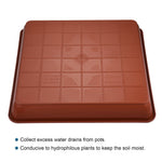 underside view of brown square plastic plant saucer showing molded grid pattern and center mark
