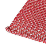Macro close-up of the textured corner of a red rectangular mesh dish scrub pad on a white background.