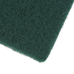 Close-up macro view of fibrous texture on a dark green scouring pad corner