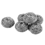 Pile of coiled stainless steel scouring pads with one pad separated on a white background