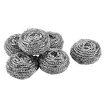 Cluster of round stainless steel wire scrubbers arranged on a white background with one beside the pile