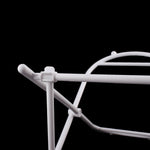 Close-up detail of a white plastic trash bag frame joint and horizontal support rod against a black background.