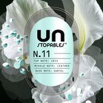 Decorative label-style graphic for Unstopables N.11 showing fragrance notes over white floral background.