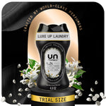 Black Unstopables N.24 in-wash scent booster bottle on a pedestal with white floral accents and scent beads