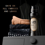Single UNSTOPABLES N.26 scent booster bottle staged beside folded garments on a dark background with text claiming safe on all fabrics