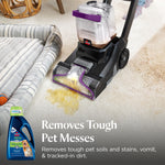 Upright carpet cleaner extracting a yellow pet stain from carpet with product bottle inset and headline text